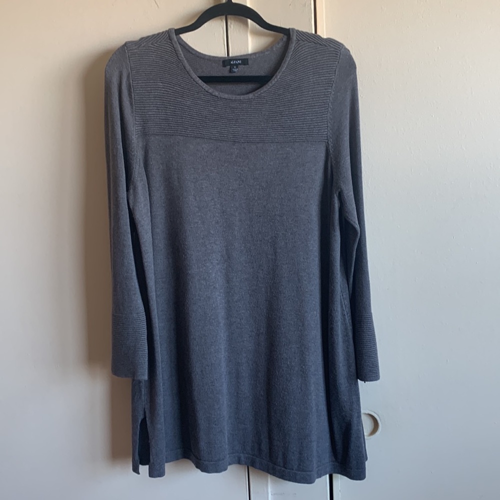 A grey sweater with sequins on the front